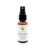 Bottle of all-natural toilet spray with a label on a white background. Lemongrass/Pine scented